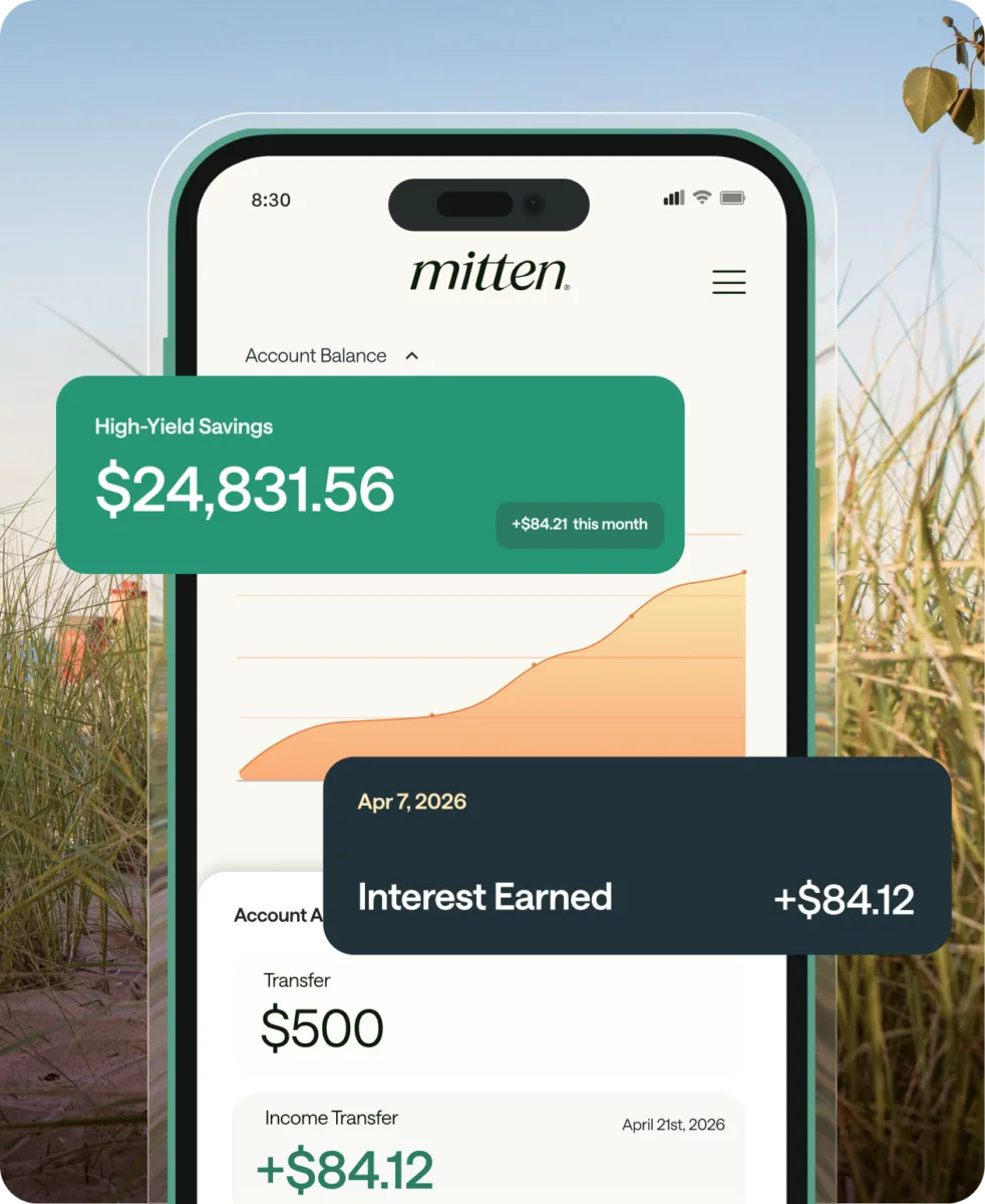 A smartphone displays a savings account balance of $24,831.56 and monthly interest earned of $84.12 in a finance app called mitten, with a background of grass and blue sky.